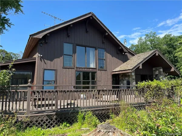a front view of house with wooden fence