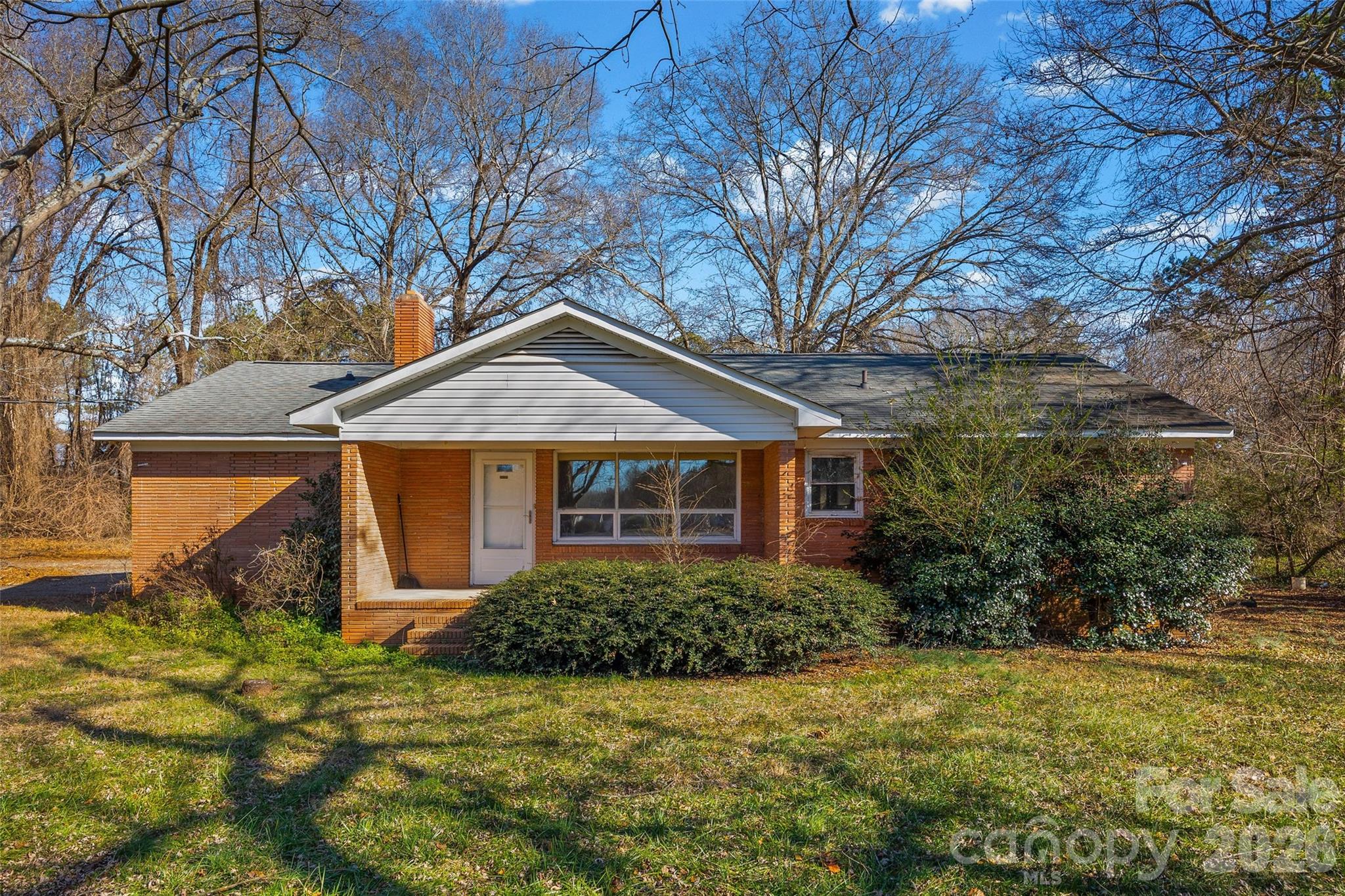 5323 South New Hope Road Belmont, NC 28012 - Photo 1 of 43 a front view of house with yard and trees around