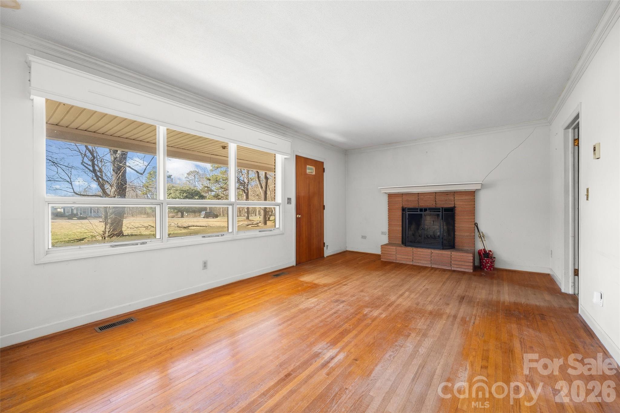 5323 South New Hope Road Belmont, NC 28012 - Photo 17 of 43 a view of an empty room with a window and wooden floor