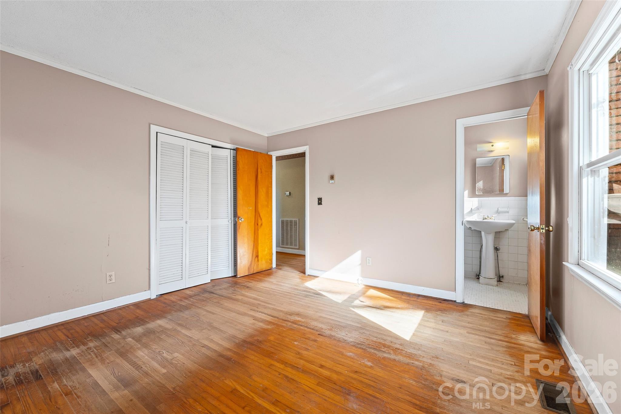 5323 South New Hope Road Belmont, NC 28012 - Photo 25 of 43 a view of an empty room with wooden floor and a window