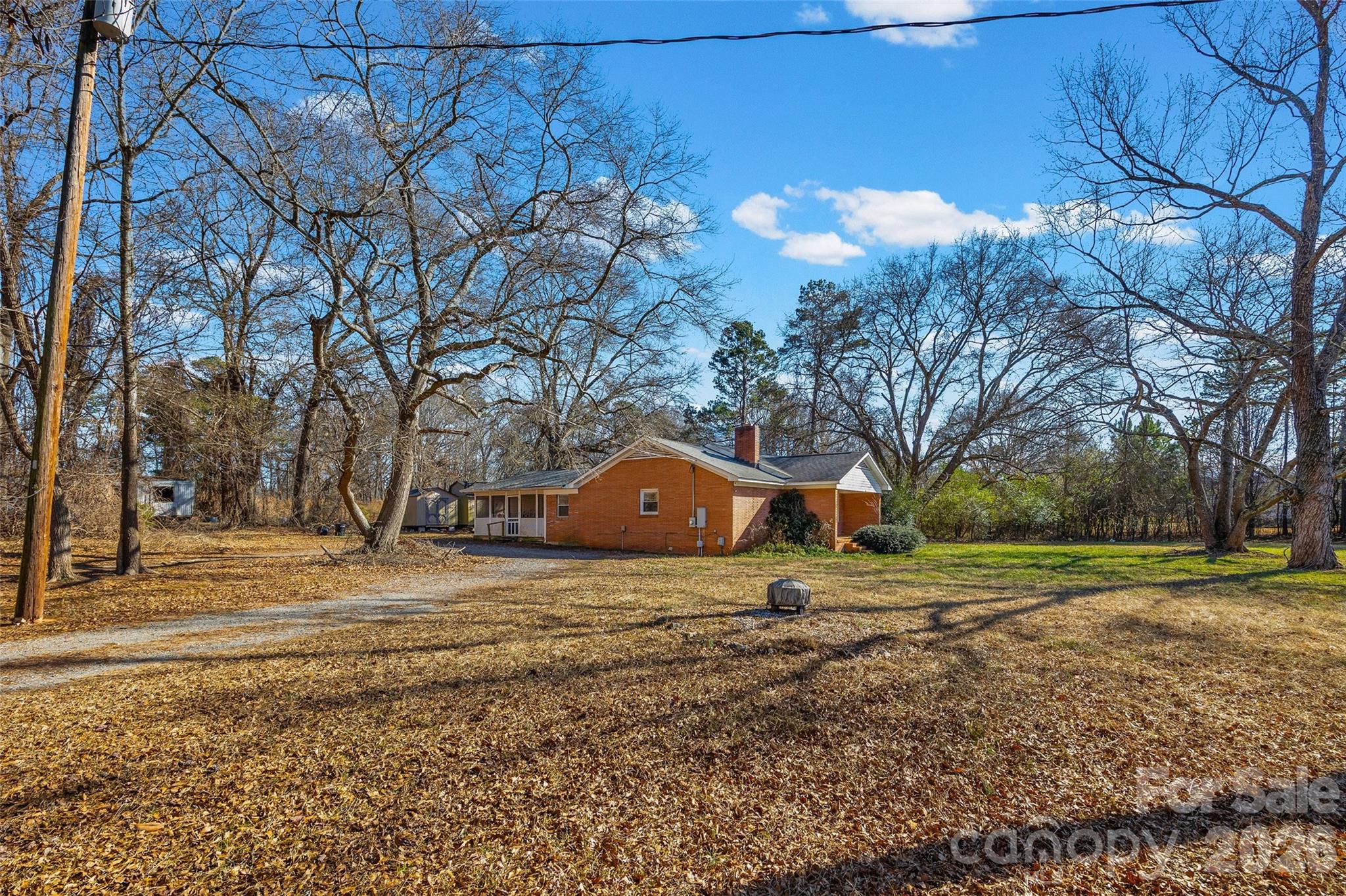 5323 South New Hope Road Belmont, NC 28012 - Photo 26 of 43 a backyard of a house with trees and swing