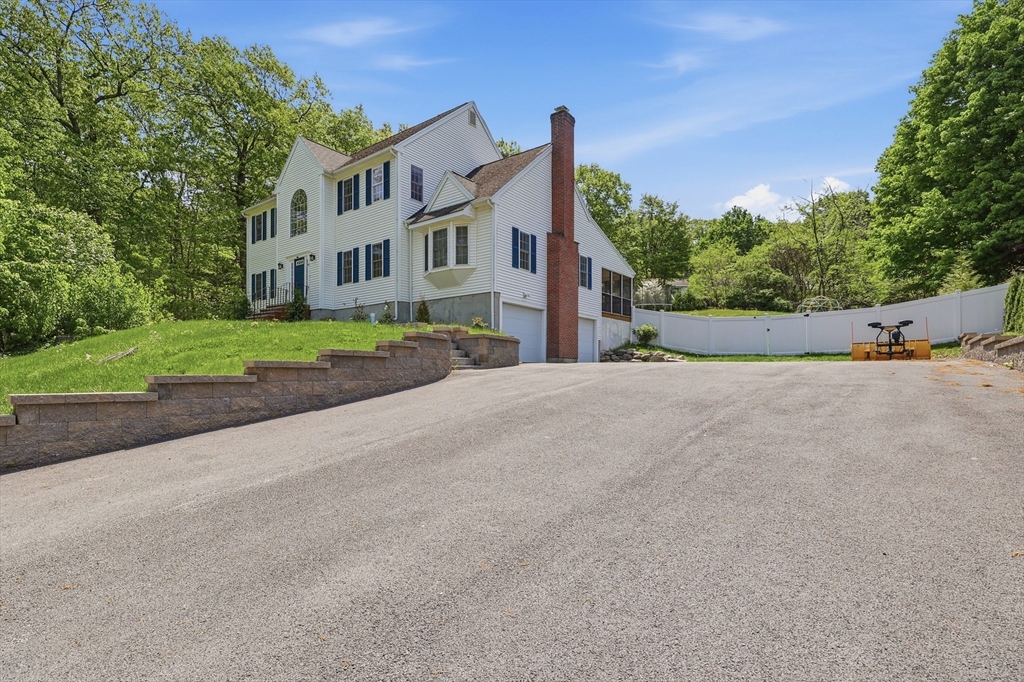 61 Indian Head Road Framingham, MA 01701 - Photo 5 of 42 a front view of a house with a yard and garage