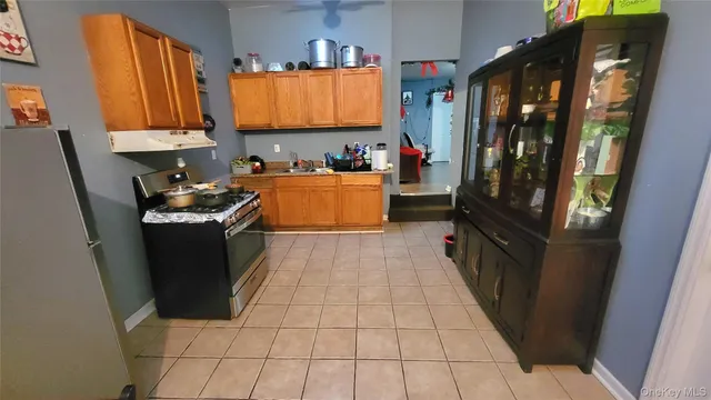 a kitchen with stainless steel appliances a refrigerator and a stove