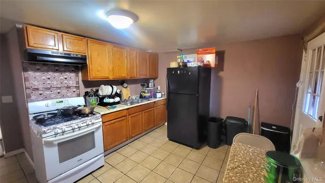 a kitchen with stainless steel appliances granite countertop a refrigerator stove and sink