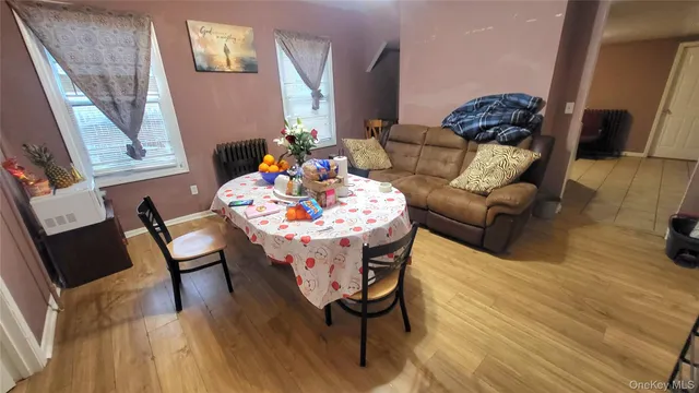 a dining room with furniture and wooden floor