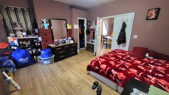 a bedroom with a bed and a mirror on dresser