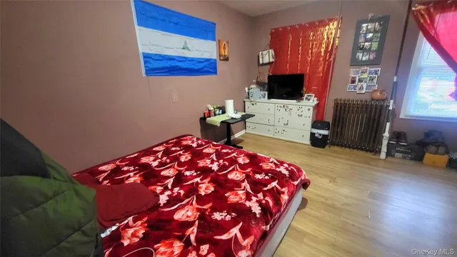 a bedroom with a bed and flat screen tv