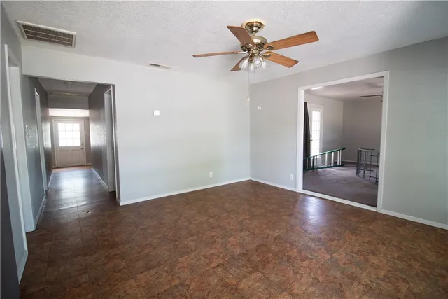 a view of a livingroom with a ceiling fan and window