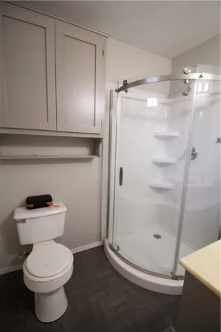 a bathroom with a toilet and a shower