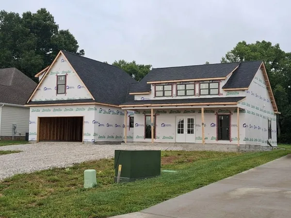 a front view of a house with a garden
