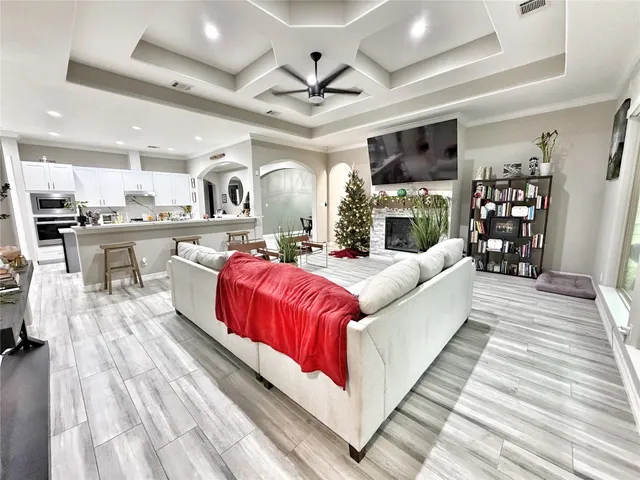 a living room with stainless steel appliances kitchen island granite countertop furniture and a kitchen view