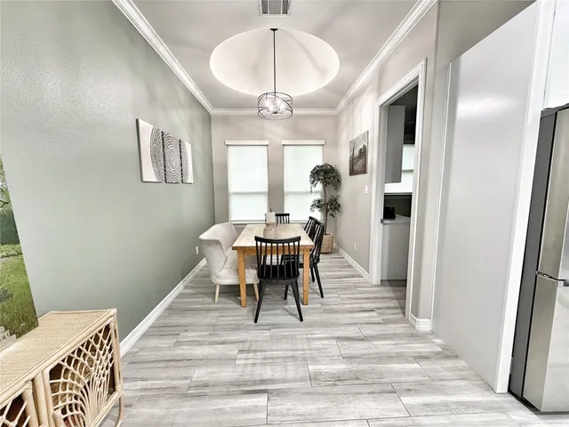 a dining room with a table and chairs