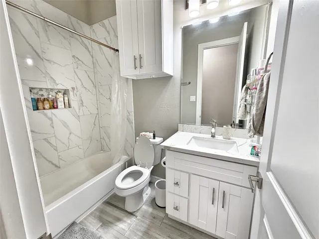 a bathroom with a sink toilet and shower