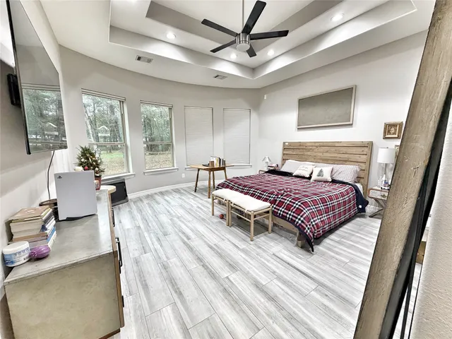a bedroom with a bed and wooden floor