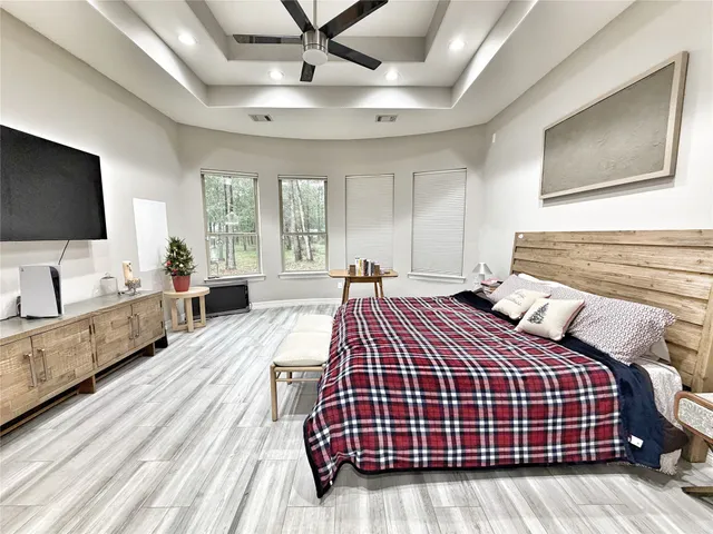 a bedroom with bed and flat screen tv