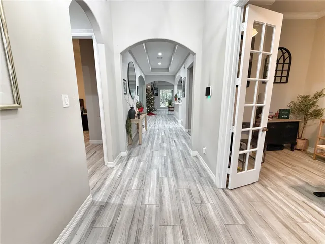 a view of a hallway with wooden floor and staircase