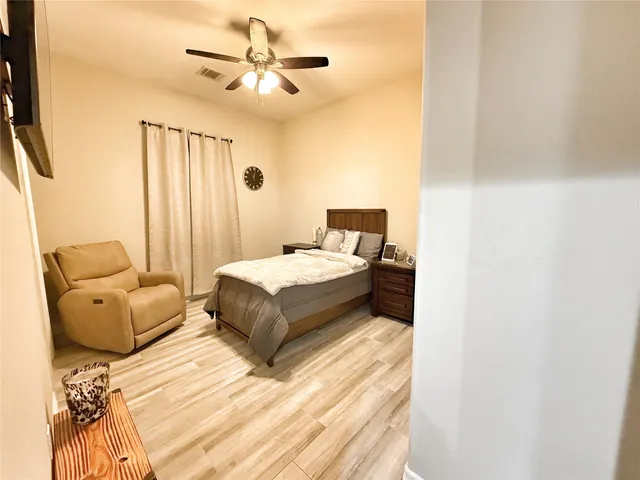 a bedroom with a bed couch and window