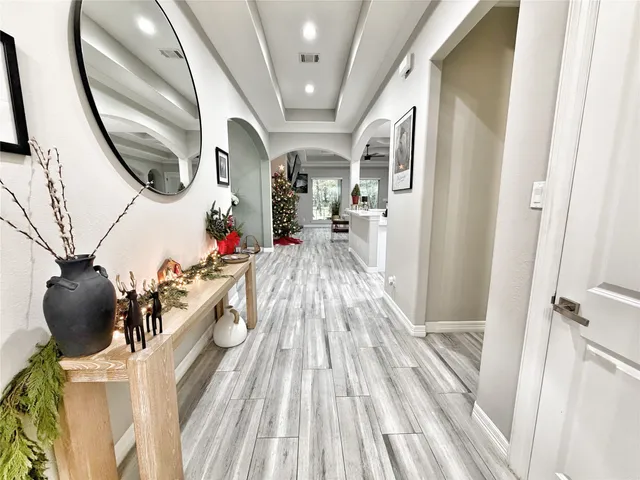 a view of a hallway and wooden floor