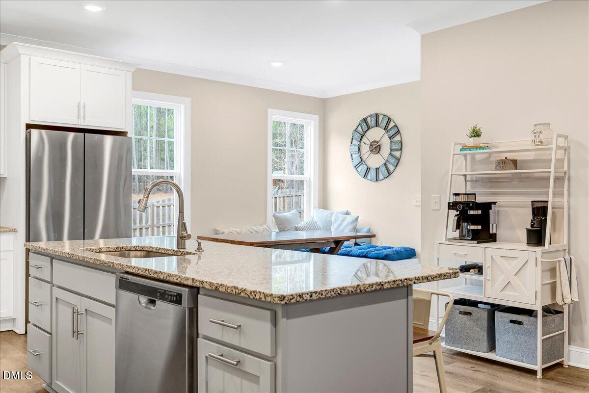 1208 Montgomery Road Franklinton, NC 27525 - Photo 10 of 61 a kitchen with granite countertop a sink and a stove