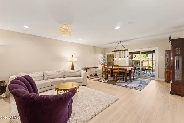 a living room with furniture a clock and a flat screen tv