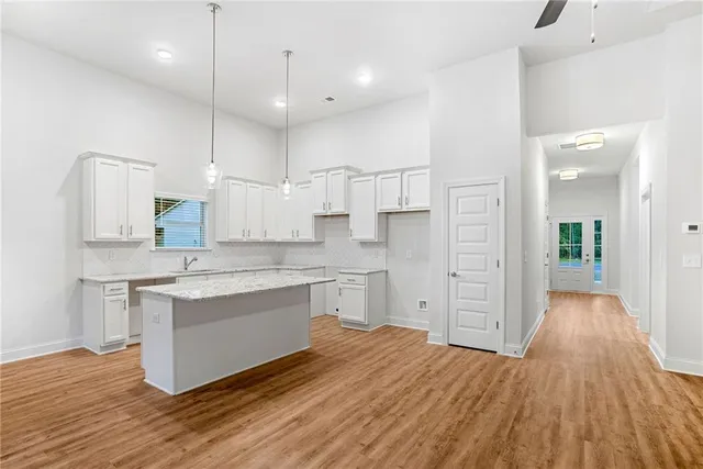 a kitchen with granite countertop a sink stove and cabinets