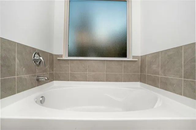 a bathroom with a double vanity sink mirror and shower