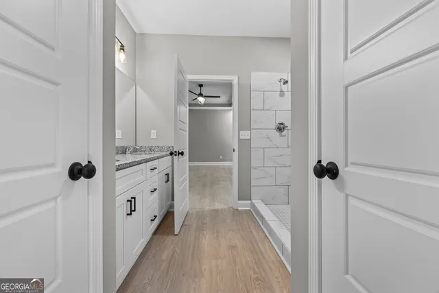a bathroom with a double vanity sink toilet and shower
