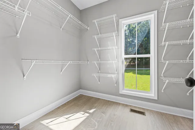 a view of a room with a window and a ceiling fan