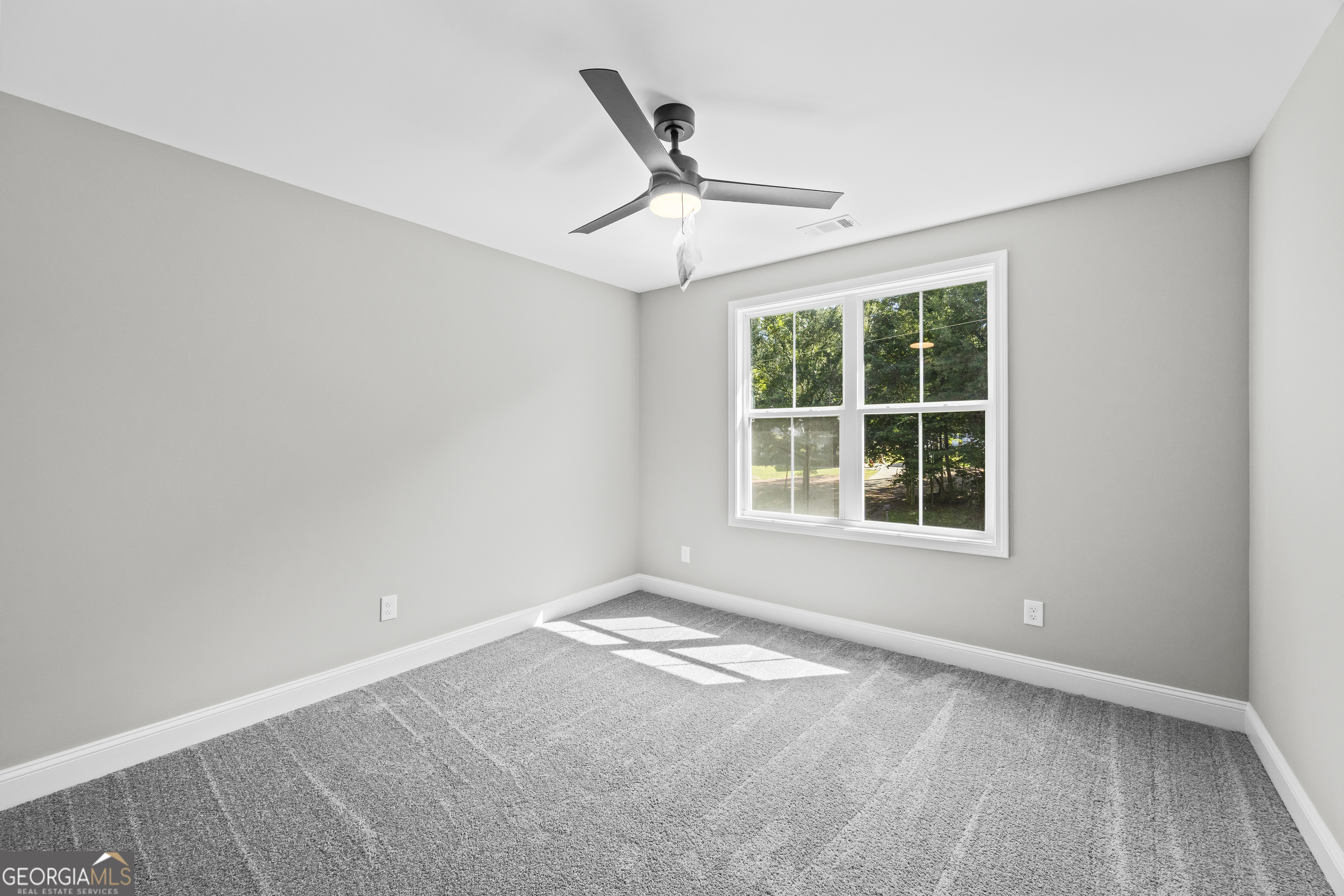 119 Gordon Road Commerce, GA 30530 - Photo 24 of 40 an empty room with a window and ceiling fan