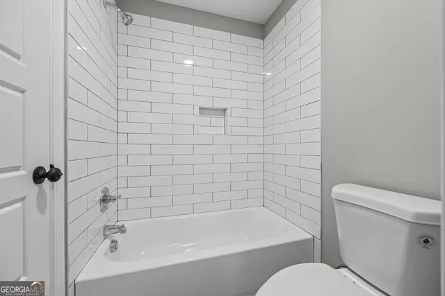 a bathroom with a toilet and a bathtub