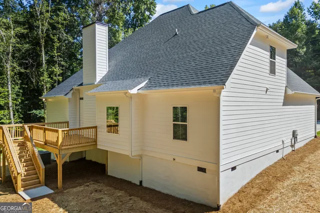 a view of a patio with table and chairs with wooden floor and fence