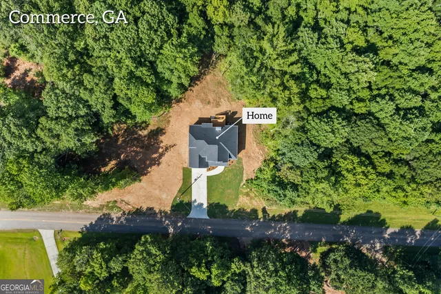 an aerial view of a house with a yard