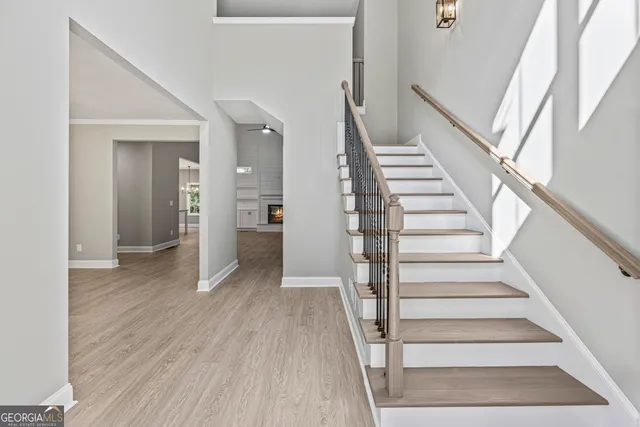 a view of entryway and hall with wooden floor