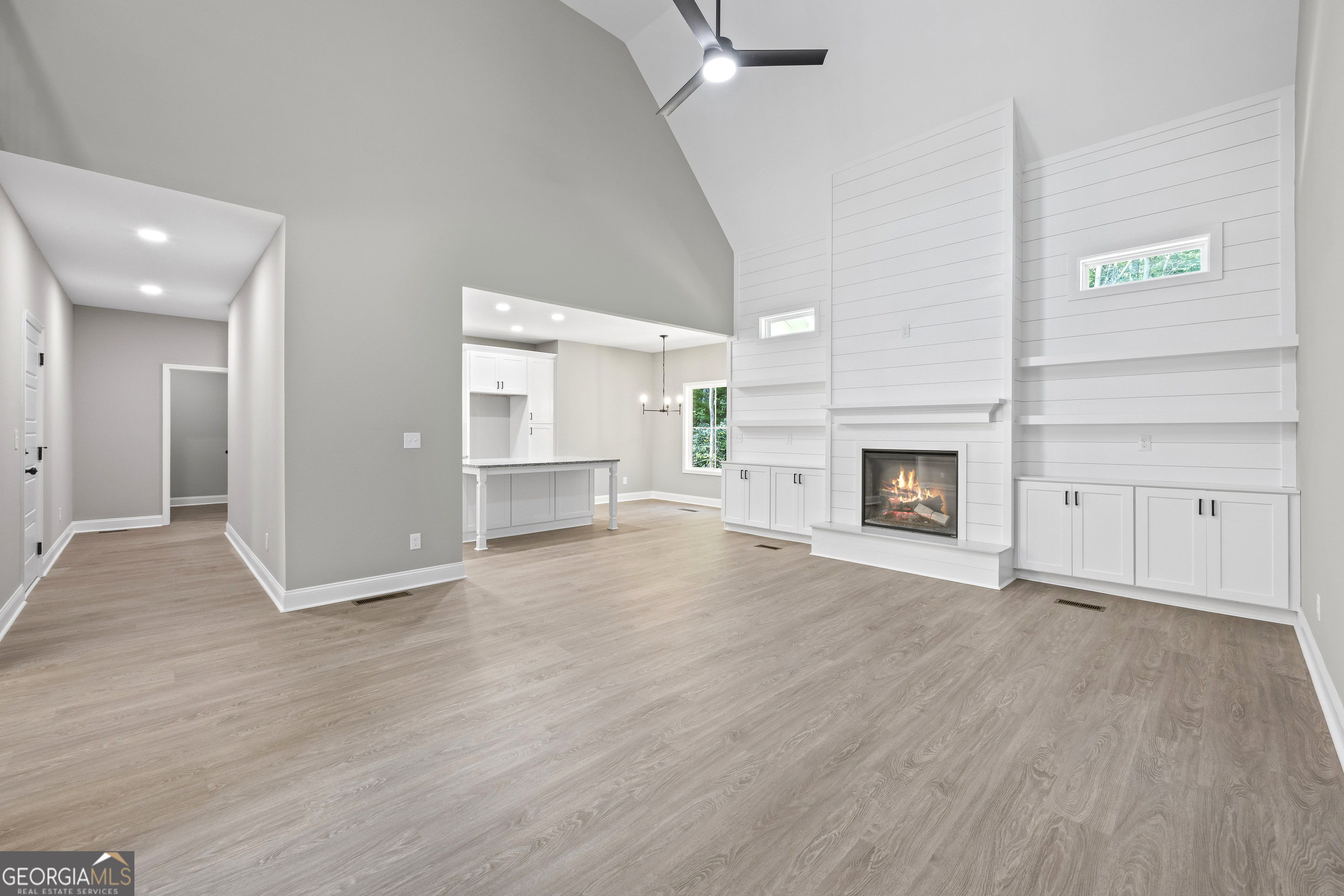 119 Gordon Road Commerce, GA 30530 - Photo 7 of 40 an empty room with wooden floor fireplace and windows