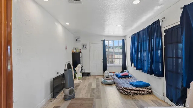 a living room with furniture and musical instruments