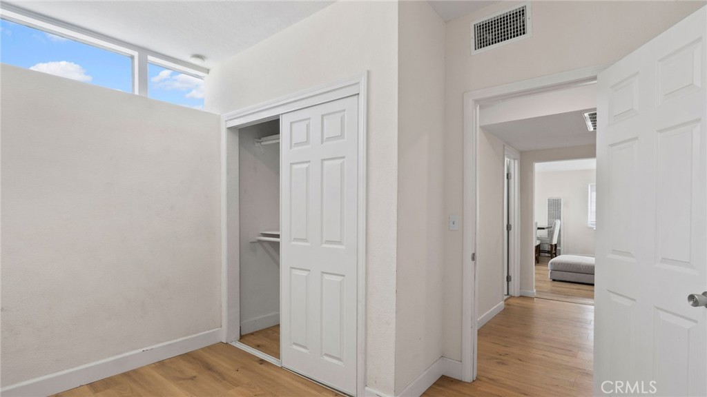 8035 Santa Rita Street Corona, CA 92881 - Photo 15 of 37 a view of a hallway with wooden floor