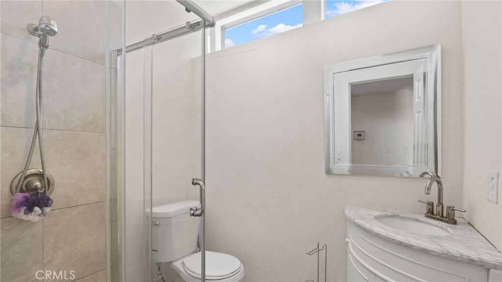 8035 Santa Rita Street Corona, CA 92881 - Photo 17 of 37 a bathroom with a sink a toilet and shower