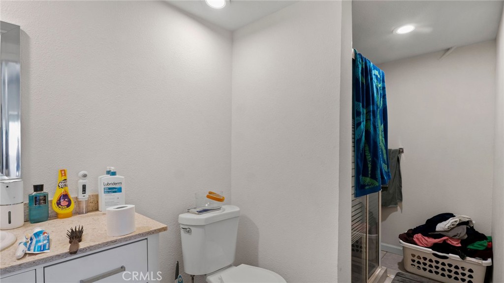 8035 Santa Rita Street Corona, CA 92881 - Photo 20 of 37 a bathroom with a sink a toilet and a shower curtain