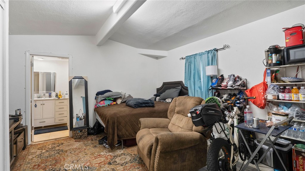 8035 Santa Rita Street Corona, CA 92881 - Photo 26 of 37 a room with furniture a rug and a window