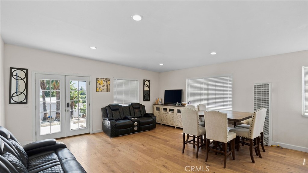 8035 Santa Rita Street Corona, CA 92881 - Photo 6 of 37 a living room with furniture a flat screen tv and a window