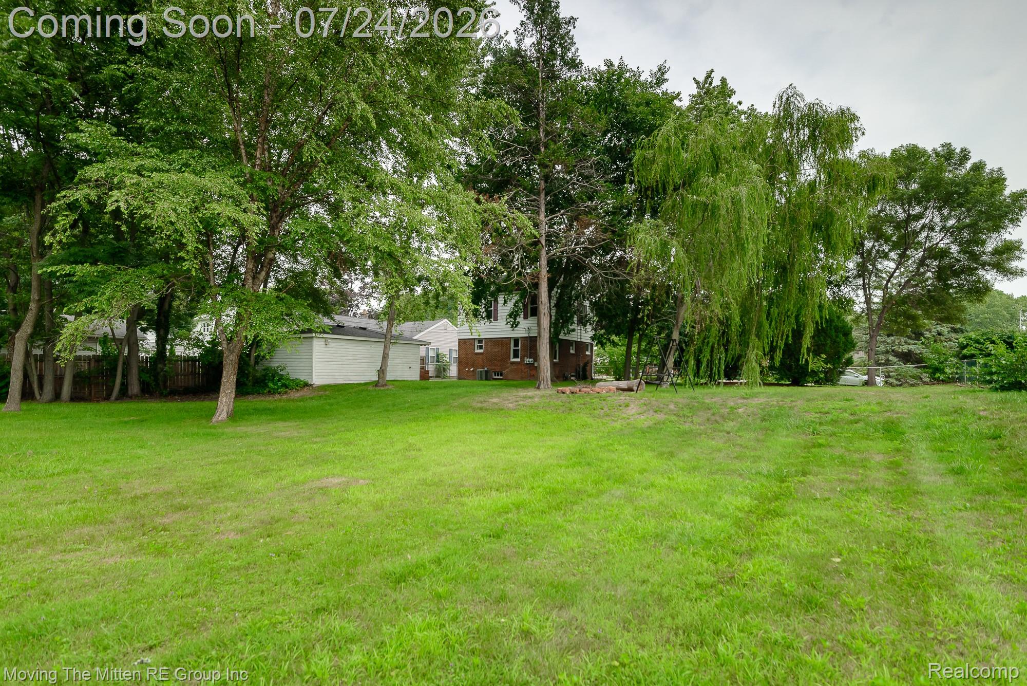 2037 Vivian Road Monroe, MI 48162 - Photo 32 of 39 Expansive grassy lawn with mature trees and a weeping willow