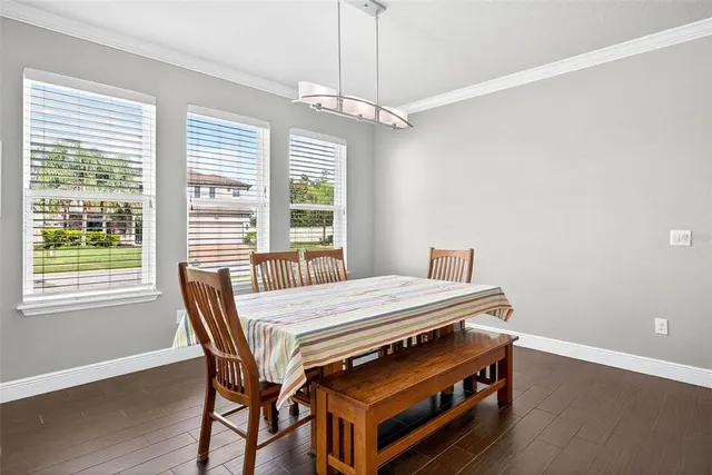a kitchen with kitchen island granite countertop a sink and white cabinets