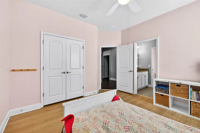 a bedroom with a bed a desk and chair