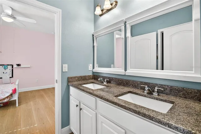 a bathroom with a double vanity sink mirror and