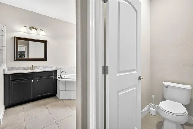 a living room with furniture and a ceiling fan