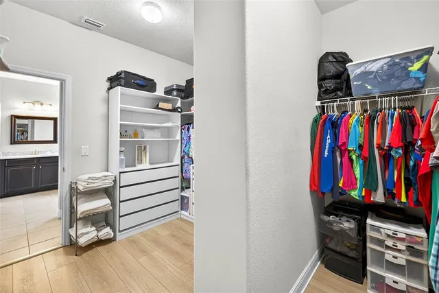 a bathroom with a granite countertop toilet and a sink