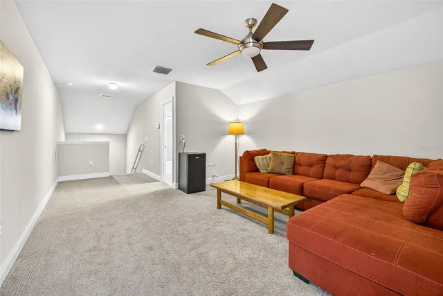 an aerial view of a house with a swimming pool and outdoor seating
