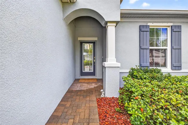a hallway with wooden floor chandelier and hallway