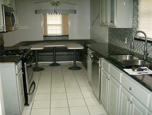 a kitchen with a sink a stove and a window