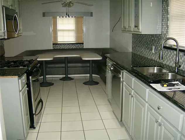 a kitchen with a sink a stove and a window